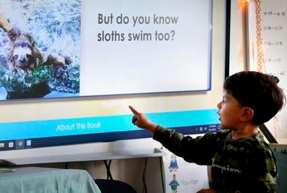  student pointing at screen